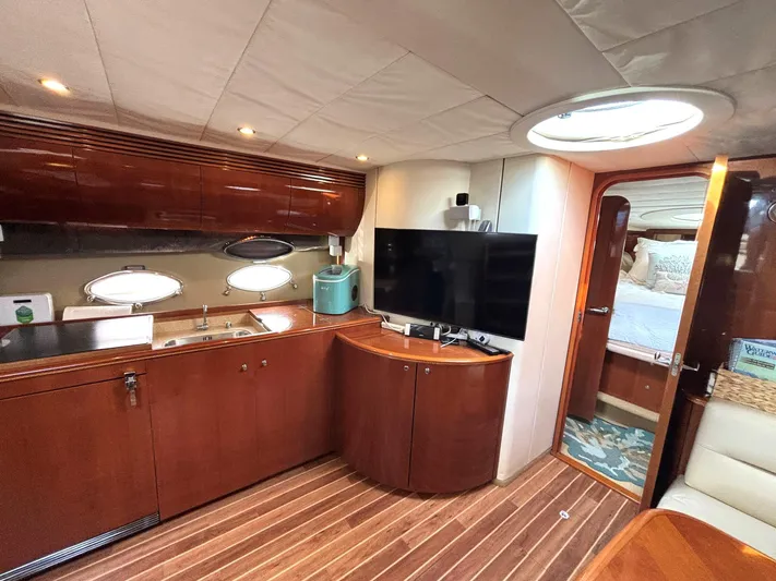Blind Date Yacht Photos Pics Luxurious interior of 2005 Viking Princess V50 yacht with modern kitchen and entertainment area.