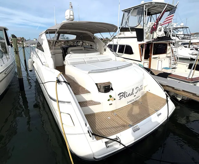 Blind Date Yacht Photos Pics 2005 Viking Princess V50 yacht docked at marina, featuring spacious deck and sleek design.