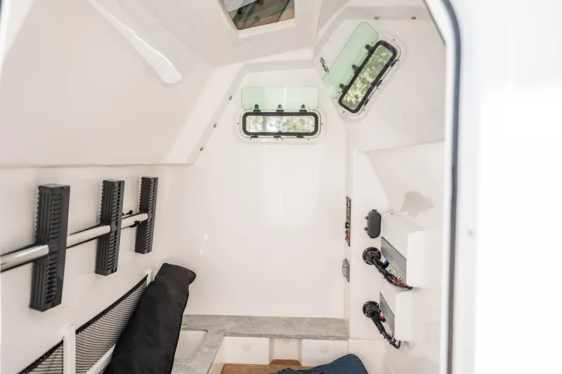  Yacht Photos Pics Interior cabin of 2021 Everglades 335 Center Console boat, featuring windows and storage.