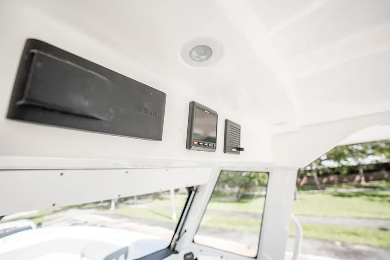  Yacht Photos Pics 2021 Everglades 335 Center Console interior with electronic controls and speaker system.