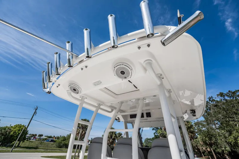  Yacht Photos Pics 2021 Everglades 335 Center Console boat with rod holders and speakers under a clear sky.