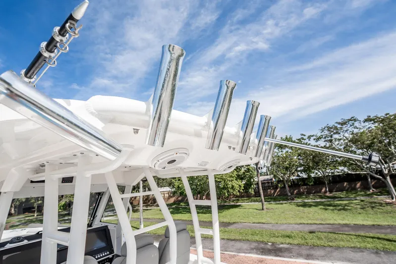  Yacht Photos Pics 2021 Everglades 335 Center Console boat with rod holders and blue sky background.