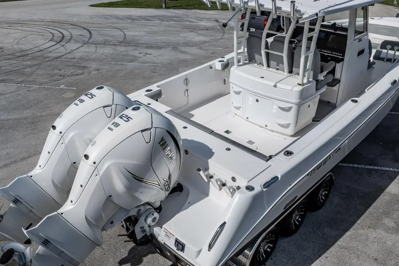  Yacht Photos Pics 2021 Everglades 335 Center Console boat with twin Yamaha 425 V8 engines, parked on pavement.