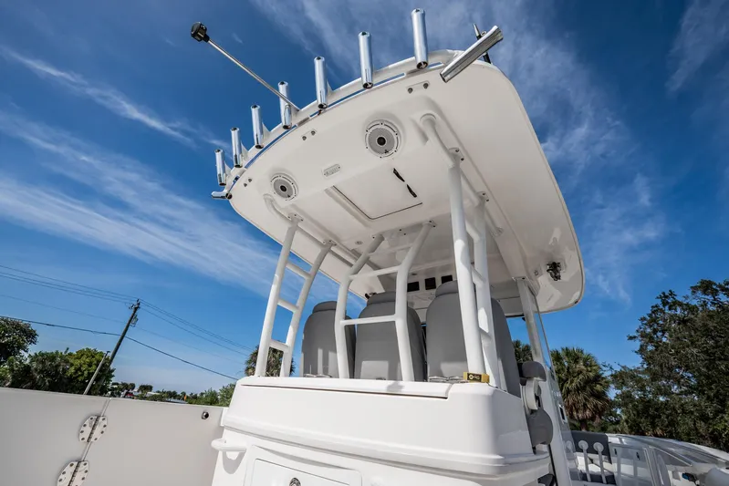  Yacht Photos Pics 2021 Everglades 335 Center Console boat with T-top under a clear blue sky.
