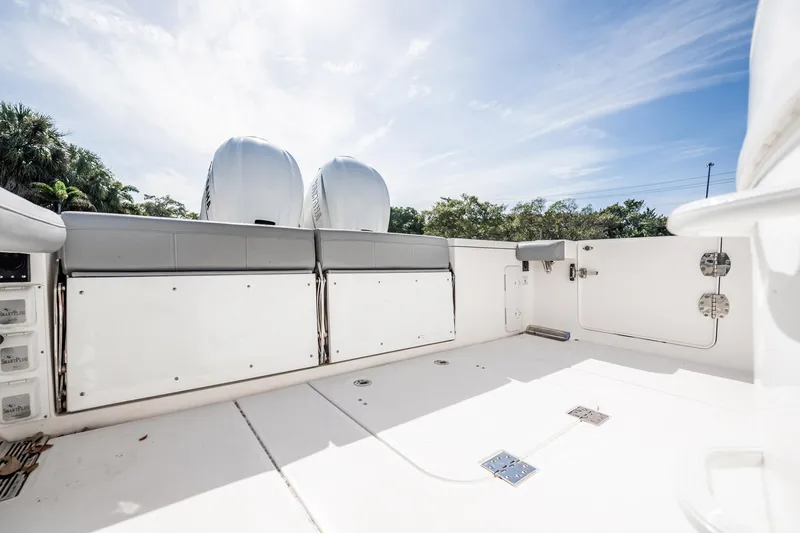  Yacht Photos Pics 2021 Everglades 335 Center Console boat deck with dual engines, under a clear sky.