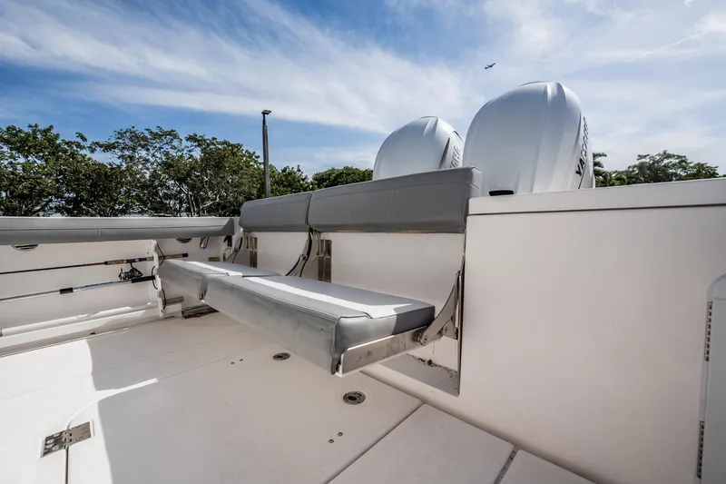 Yacht Photos Pics 2021 Everglades 335 Center Console boat with dual engines and seating, under a clear sky.