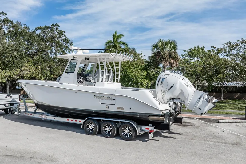  Yacht Photos Pics 2021 Everglades 335 Center Console boat on trailer, parked outdoors.
