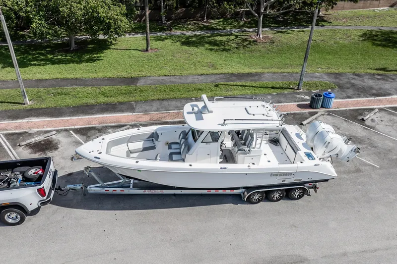  Yacht Photos Pics 2021 Everglades 335 Center Console boat on trailer, parked in a lot.