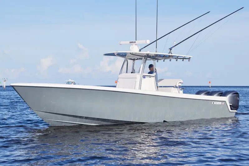  Yacht Photos Pics 2022 Contender 35 ST boat on calm ocean waters, featuring triple outboard engines.
