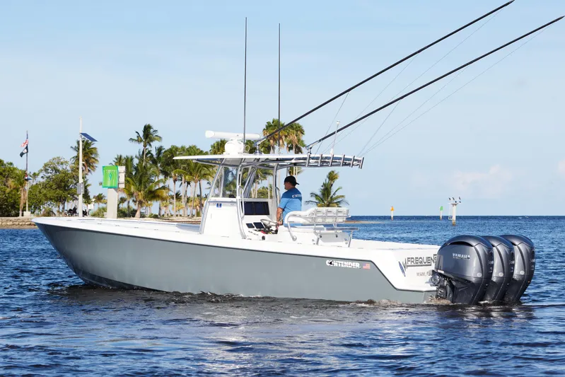  Yacht Photos Pics 2022 Contender 35 ST boat cruising on water with triple Yamaha engines.