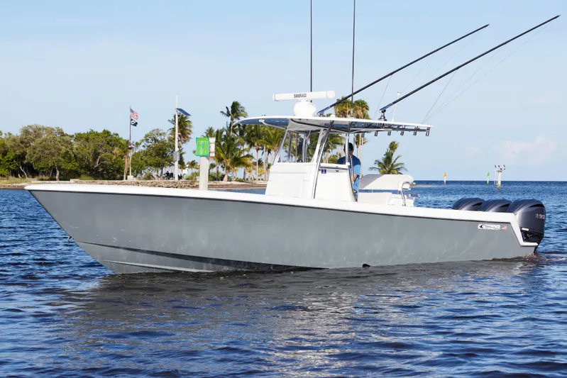  Yacht Photos Pics 2022 Contender 35 ST boat on water with palm trees in background.