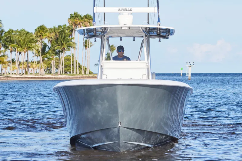  Yacht Photos Pics 2022 Contender 35 ST boat cruising near tropical shoreline.