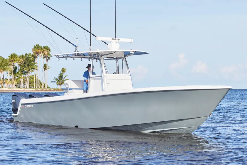  Yacht Photos Pics 2022 Contender 35 ST boat cruising on calm waters with palm trees in the background.