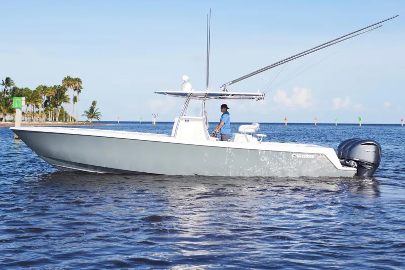  Yacht Photos Pics 2022 Contender 35 ST boat cruising on open water with palm trees in the background.