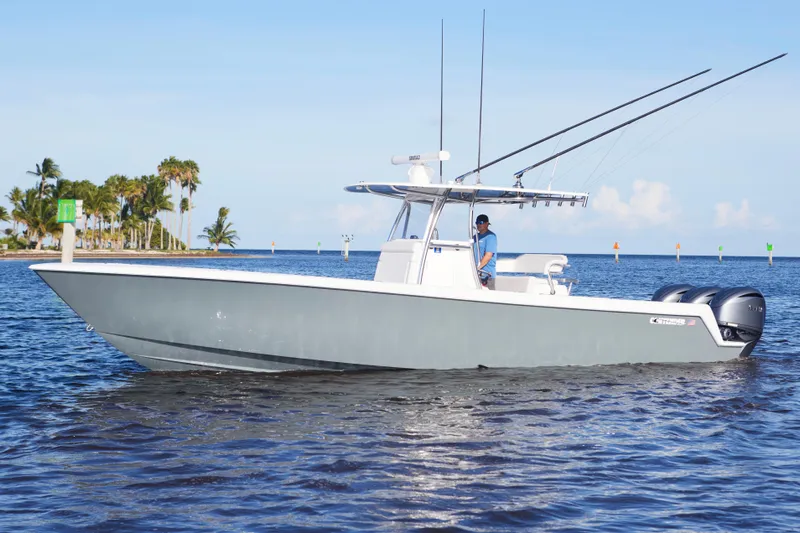 Yacht Photos Pics 2022 Contender 35 ST boat cruising on calm waters near a tropical shoreline.