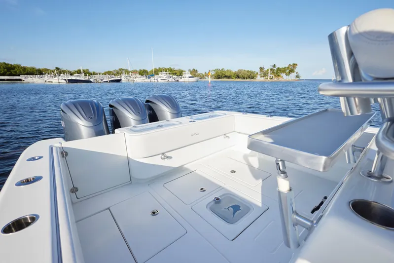  Yacht Photos Pics 2022 Contender 35 ST boat with triple engines, docked in a scenic marina.