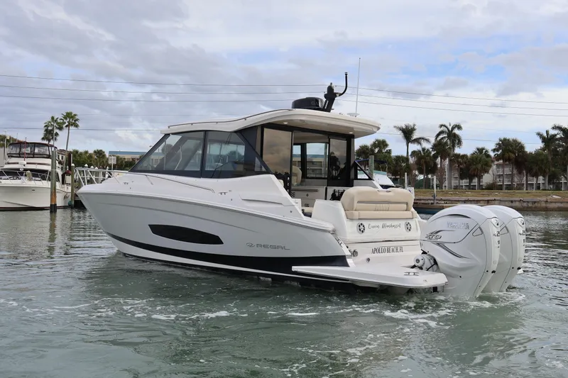  Yacht Photos Pics 2022 Regal 36 XO boat on water, featuring sleek design and twin outboard engines.