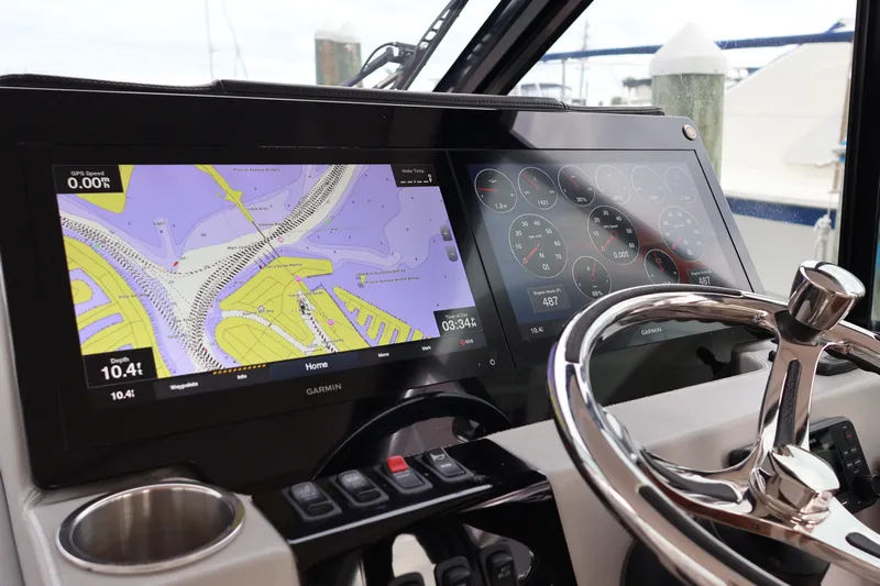  Yacht Photos Pics 2022 Regal 36 XO helm with dual Garmin displays and stainless steel steering wheel.