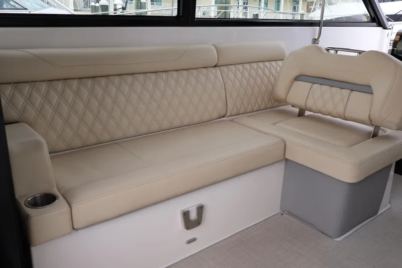  Yacht Photos Pics Luxurious beige seating on 2022 Regal 36 XO boat, featuring diamond stitching and integrated cup holder.
