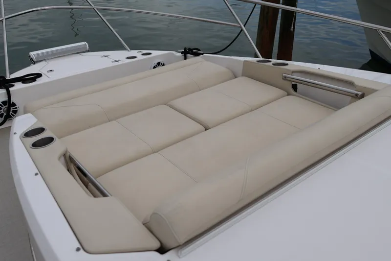  Yacht Photos Pics Luxurious seating area on 2022 Regal 36 XO boat, featuring beige upholstery and cup holders.