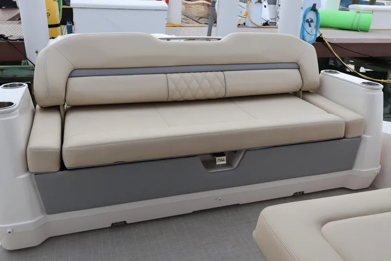 Yacht Photos Pics Luxurious seating on 2022 Regal 36 XO boat, featuring beige upholstery and cup holders.