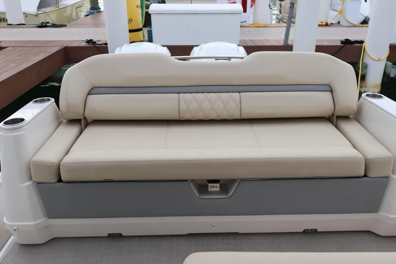  Yacht Photos Pics Beige seating on 2022 Regal 36 XO boat, docked with cup holders.