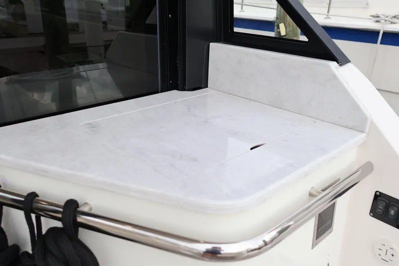  Yacht Photos Pics 2022 Regal 36 XO boat interior with sleek countertop and stainless steel railing.