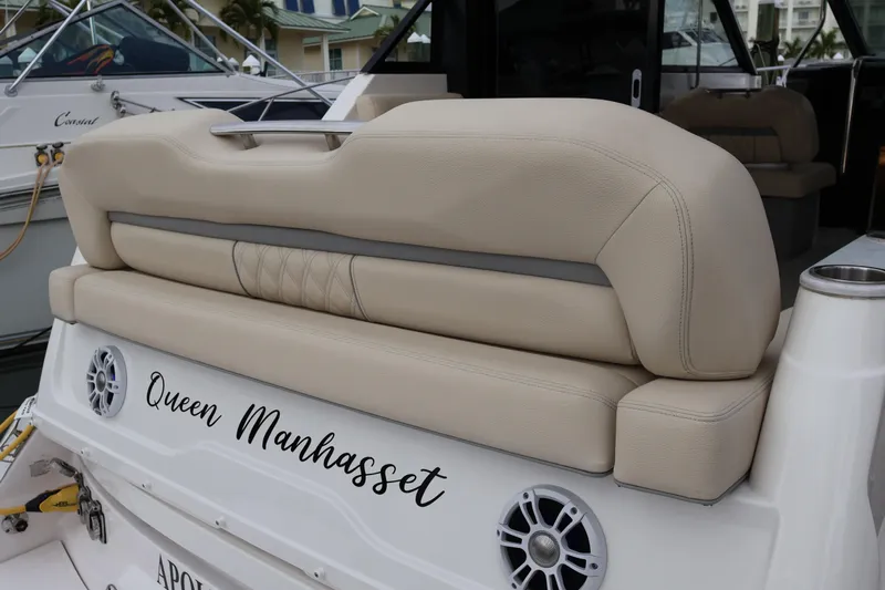  Yacht Photos Pics 2022 Regal 36 XO boat with beige seating and "Queen Manhasset" text on the stern.
