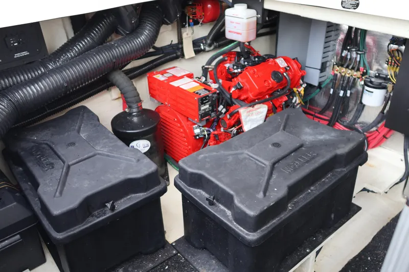  Yacht Photos Pics Engine compartment of 2022 Regal 36 XO boat with red engine and black battery boxes.
