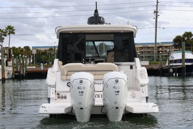  Yacht Photos Pics 2022 Regal 36 XO boat with dual outboard engines docked in marina.
