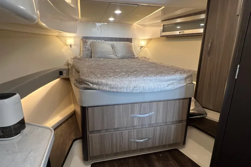  Yacht Photos Pics Luxurious cabin interior of 2022 Regal 36 XO yacht with cozy bed and modern design.