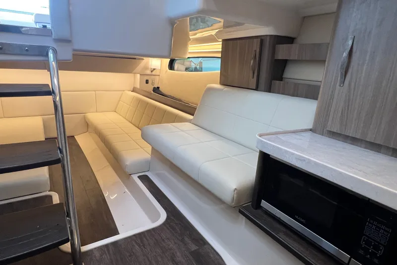  Yacht Photos Pics 2022 Regal 36 XO yacht interior with modern seating and kitchenette.