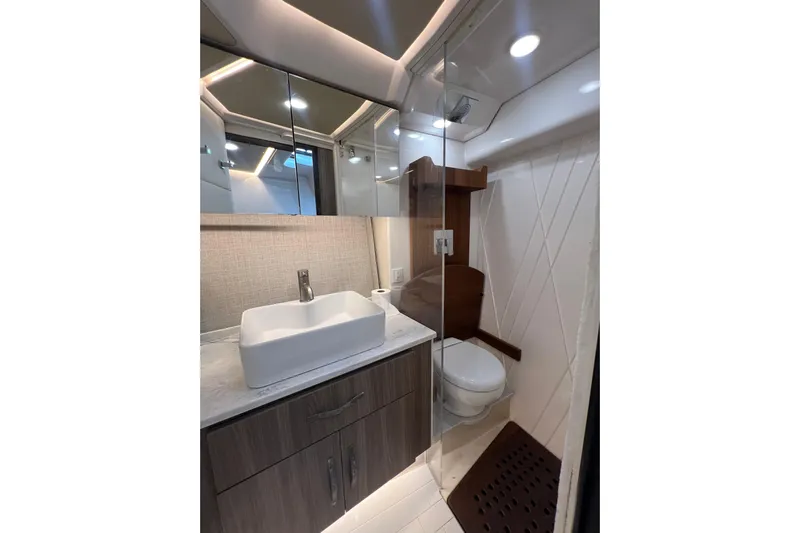  Yacht Photos Pics Luxurious bathroom in 2022 Regal 36 XO yacht with modern fixtures and elegant design.