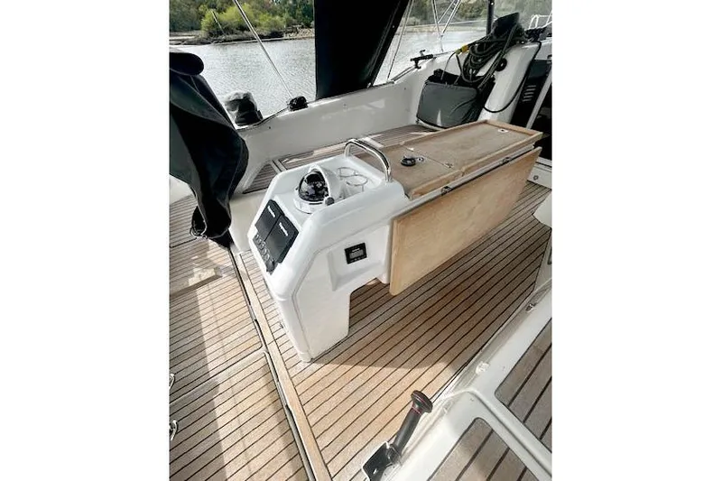 Dream Weaver Yacht Photos Pics 2022 Jeanneau Sun Odyssey 410 cockpit with wooden flooring and navigation controls.