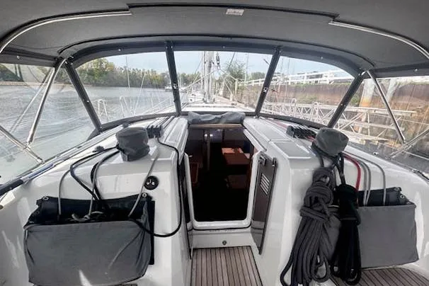 Dream Weaver Yacht Photos Pics 2022 Jeanneau Sun Odyssey 410 sailboat cockpit with covered seating and marina view.