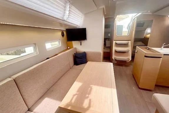 Dream Weaver Yacht Photos Pics Interior of 2022 Jeanneau Sun Odyssey 410 yacht with modern seating and dining area.