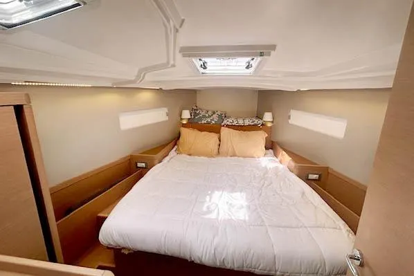 Dream Weaver Yacht Photos Pics Luxurious cabin interior of 2022 Jeanneau Sun Odyssey 410 sailboat with cozy bedding.