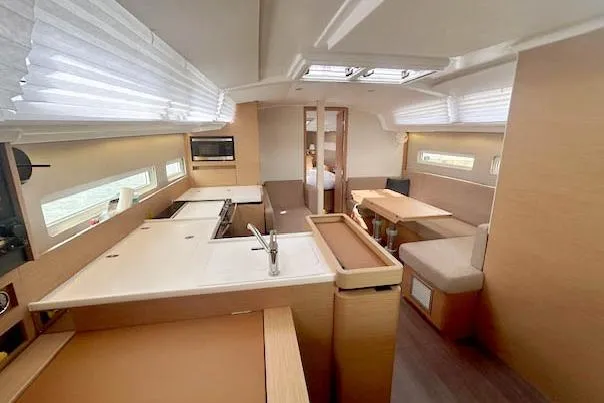 Dream Weaver Yacht Photos Pics Interior of 2022 Jeanneau Sun Odyssey 410 yacht, featuring modern kitchen and dining area.