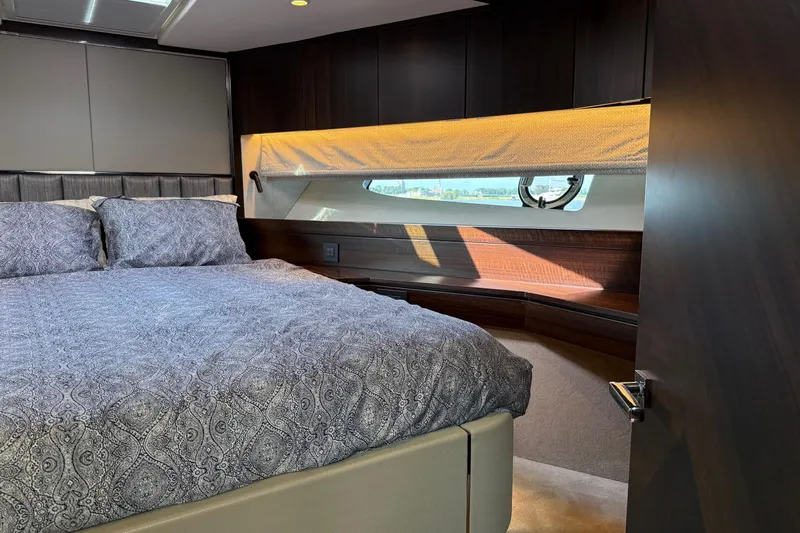  Yacht Photos Pics Luxurious bedroom interior of 2024 Sunseeker Manhattan 55 yacht with elegant bedding.
