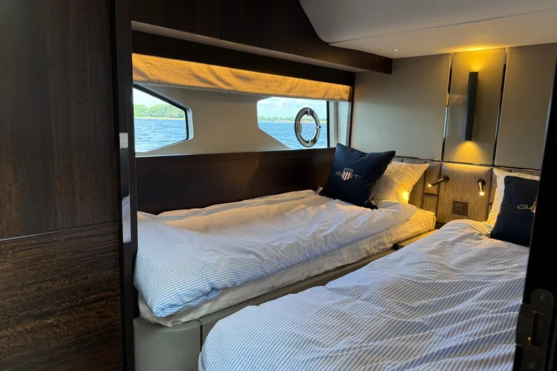  Yacht Photos Pics Luxurious cabin interior of 2024 Sunseeker Manhattan 55 yacht with twin beds.