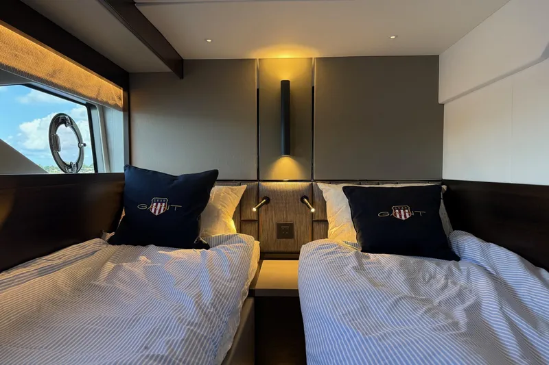  Yacht Photos Pics Luxurious twin cabin interior of 2024 Sunseeker Manhattan 55 yacht with elegant bedding.