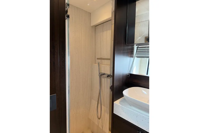  Yacht Photos Pics Luxurious bathroom in 2024 Sunseeker Manhattan 55 yacht, featuring modern fixtures and elegant design.