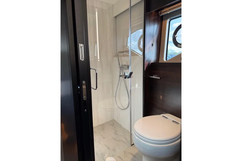  Yacht Photos Pics Luxurious bathroom in 2024 Sunseeker Manhattan 55 yacht with modern shower and toilet.