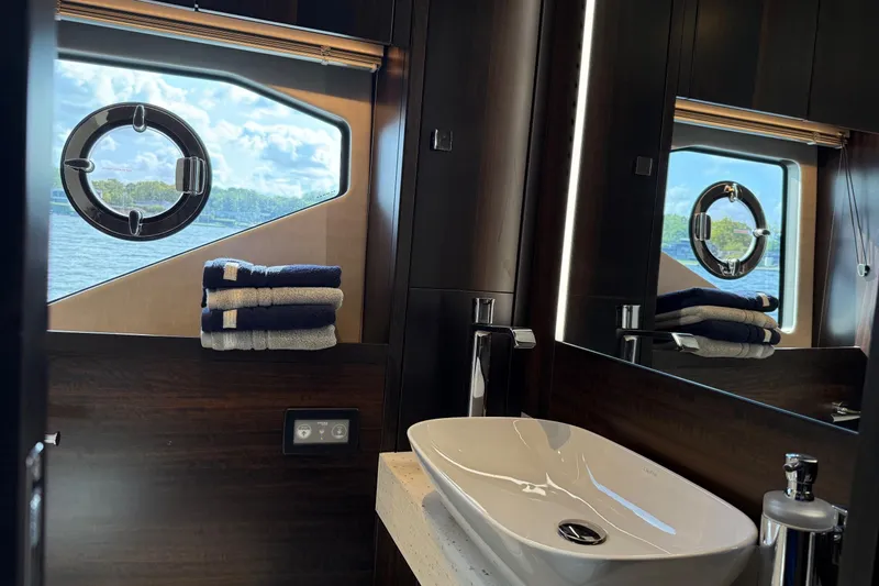  Yacht Photos Pics Luxurious bathroom interior of 2024 Sunseeker Manhattan 55 yacht with ocean view.