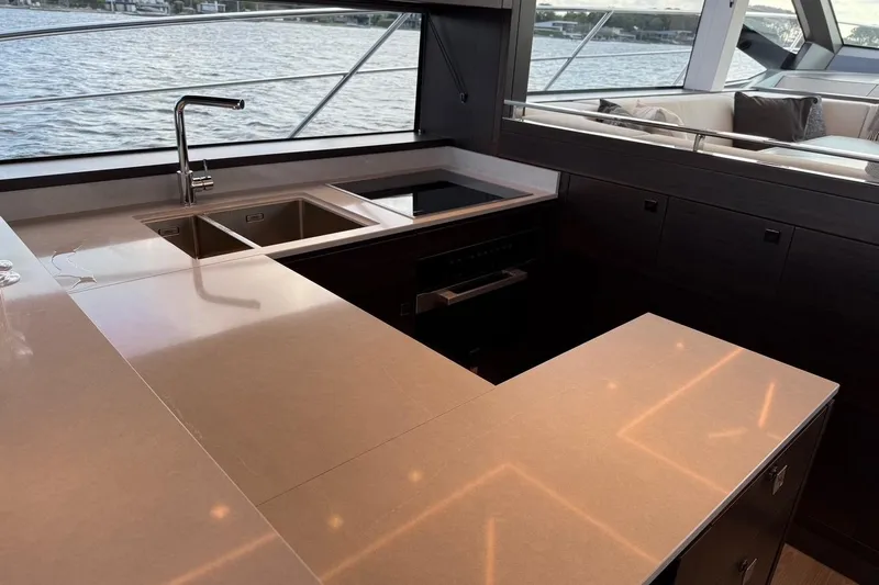  Yacht Photos Pics Luxurious kitchen interior of 2024 Sunseeker Manhattan 55 yacht with modern fixtures.