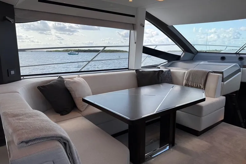  Yacht Photos Pics Luxurious interior of 2024 Sunseeker Manhattan 55 yacht with elegant seating and scenic ocean view.
