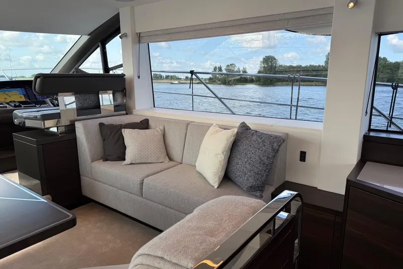  Yacht Photos Pics Luxurious interior of 2024 Sunseeker Manhattan 55 yacht with elegant seating and scenic water view.