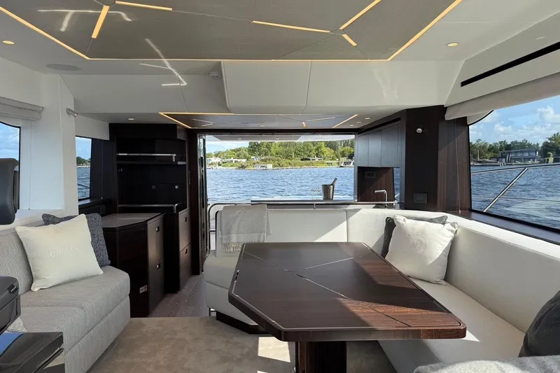  Yacht Photos Pics Luxurious interior of 2024 Sunseeker Manhattan 55 yacht with elegant seating and scenic water view.