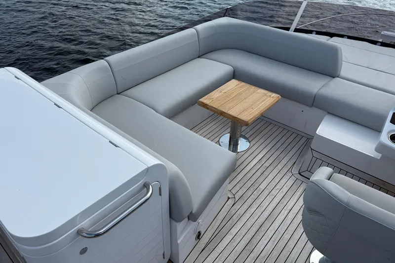  Yacht Photos Pics Luxurious seating area on 2024 Sunseeker Manhattan 55 yacht with wooden table and ocean view.