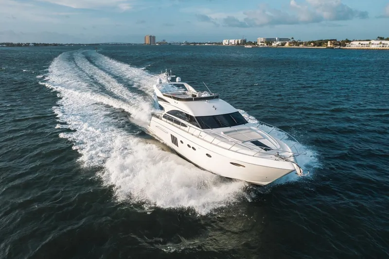 Aquavita Yacht Photos Pics 2012 Princess 64 Flybridge Motor Yacht cruising on open water, creating a dynamic wake.